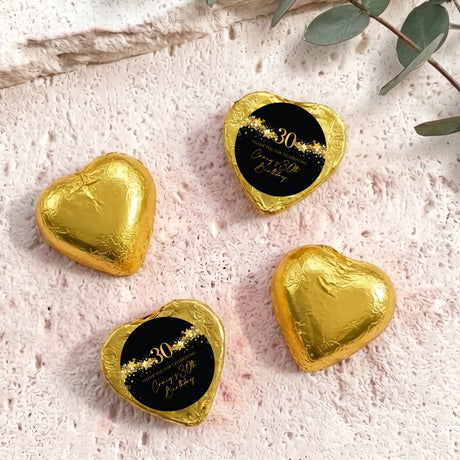 Gold foil heart chocolates with black “30” label and gold star accents