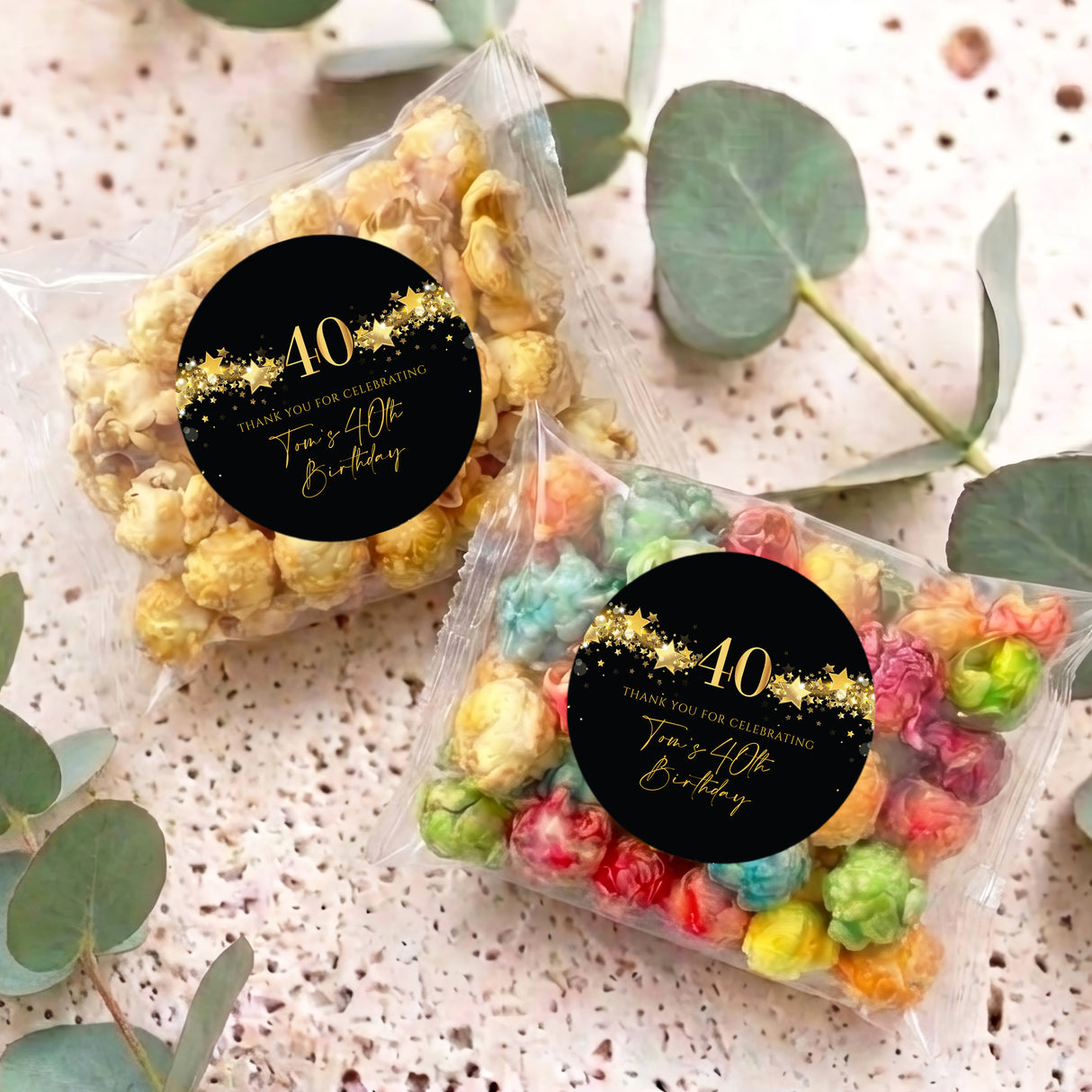 Two 40th birthday popcorn bags with clear pouches and gold star black “40” labels
