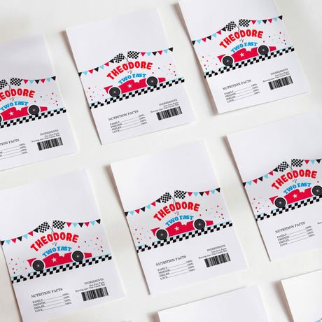 Set of white DIY chocolate wrappers with red race cars, checkered flags, and nutrition info