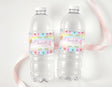 Personalised rainbow fairy birthday water bottle labels on two clear plastic bottles