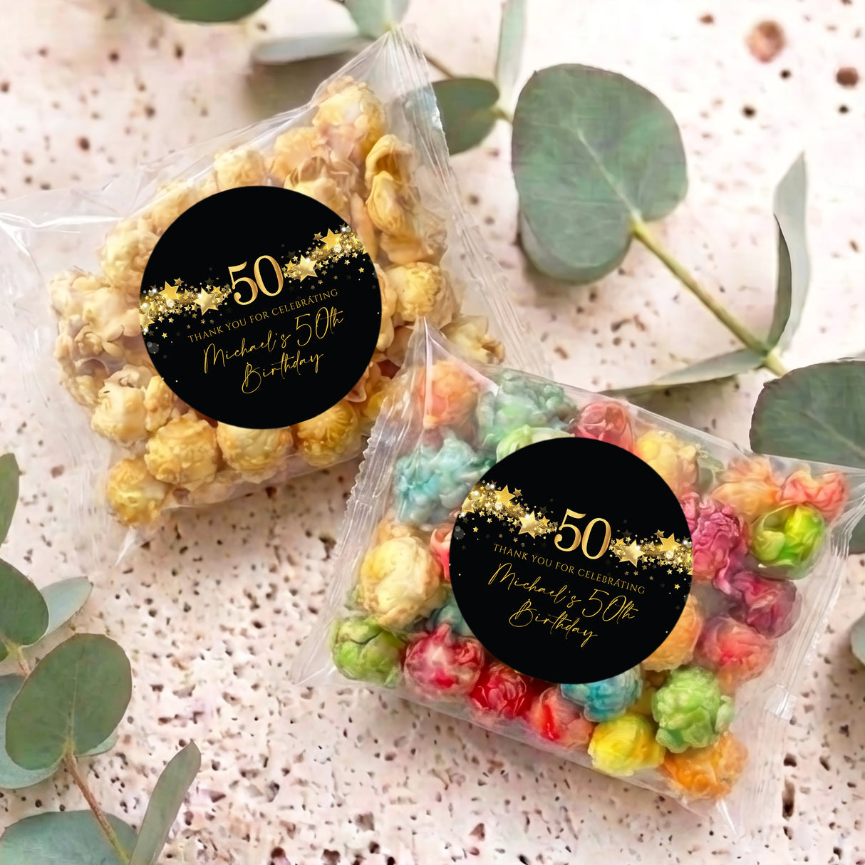 Personalised popcorn bag with clear bag filled with colorful popcorn and black gold '50' label