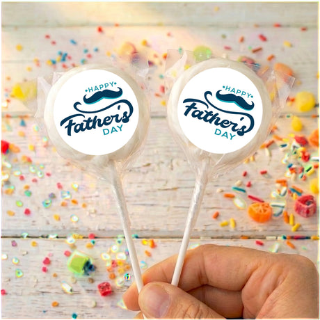 Father's Day lollipops with round 'Happy Father's Day' labels, clear wrapper, held in hand