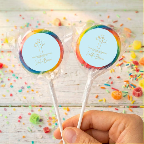 Personalised Christening lollipops with rainbow-edged blue cross labels on clear sticks