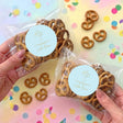 Personalised christening pretzel bag with cross sticker, clear bag, brown pretzels