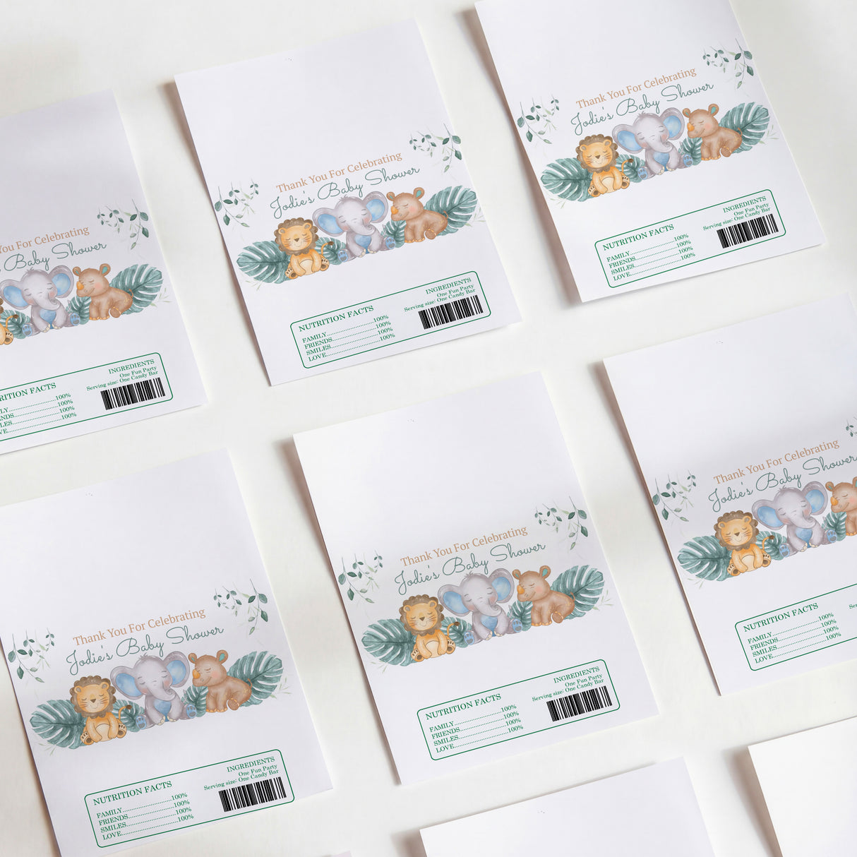 Set of white chocolate wrappers with safari animal and jungle leaf illustrations