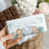 Custom first birthday chocolate bar with white wrapper, jungle animal illustrations, Elijah name.
