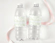 Two clear plastic water bottles with green safari-style personalised first birthday labels