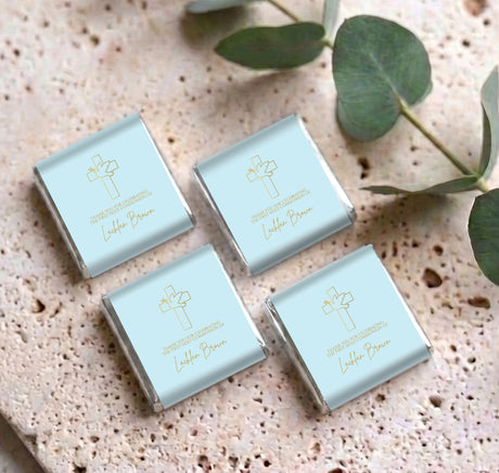 Set of four personalised mini chocolates in light blue wrappers with gold cross motifs
