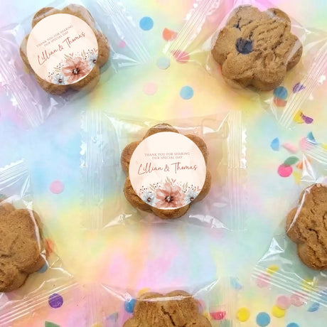 Personalised bite-size choc chip cookies with round thank-you stickers on clear wrap