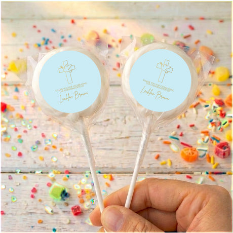 Personalised lollipops with clear wrappers, round blue labels with cross icon