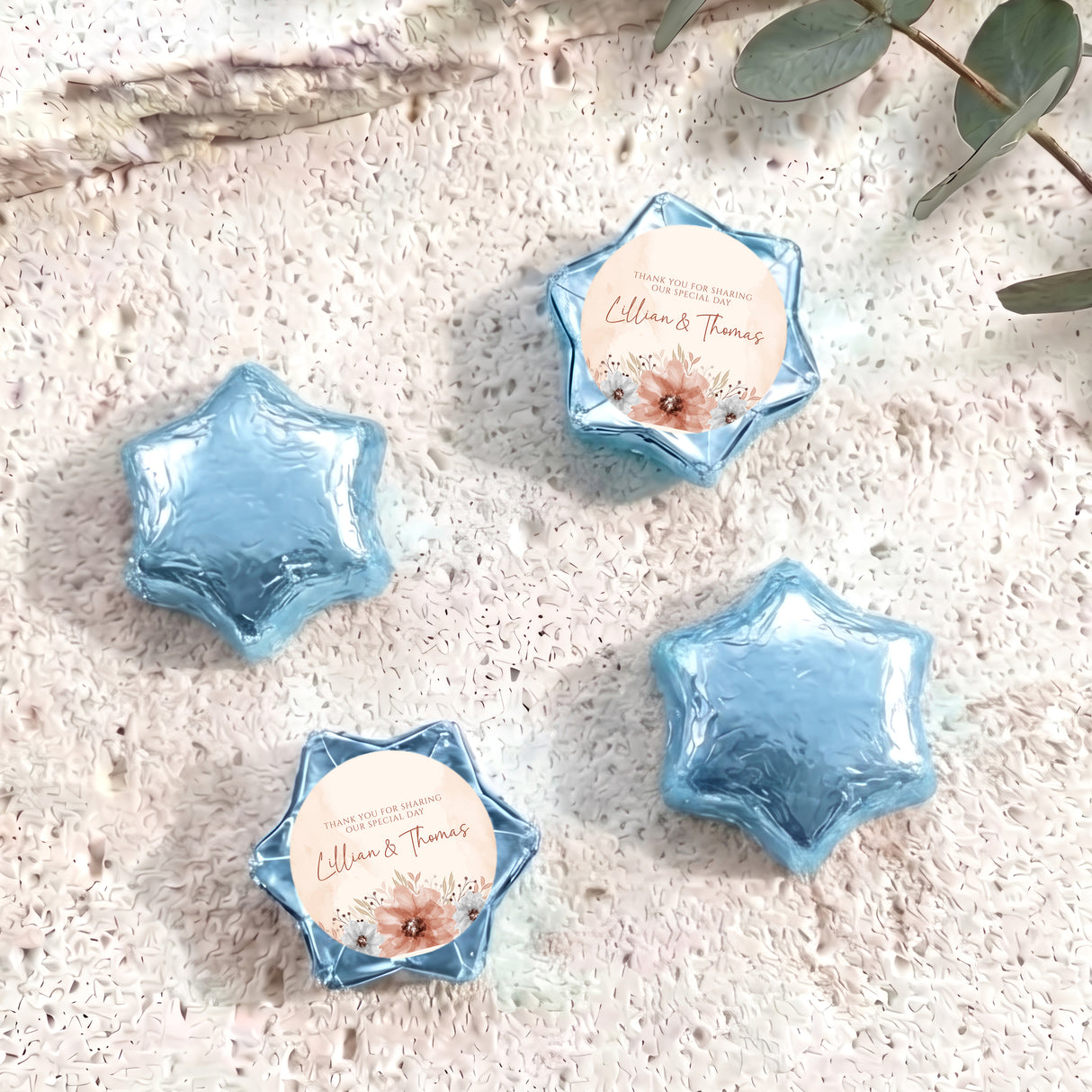 Personalised foil-covered chocolate stars with floral label, light blue star-shaped chocolates