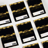 Set of 80th birthday DIY printed chocolate wrappers, black with gold stars and '80'.