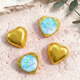 Gold foil heart chocolates for baptism, with light blue label, gold cross and name