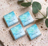 Set of blue foil mini baptism chocolates, gold cross and thank-you message wrappers