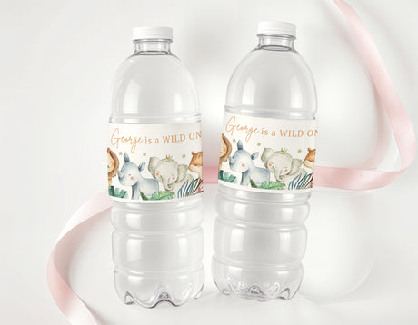 Two clear bottles with safari animal labels and printed names