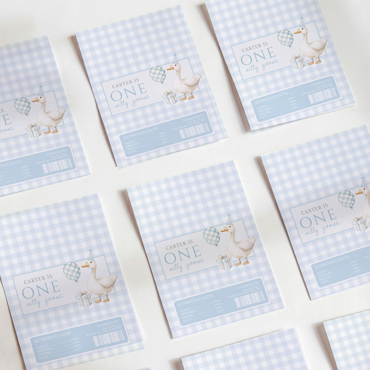 Set of first birthday chocolate wrappers, light blue gingham with 'ONE' and animal graphic