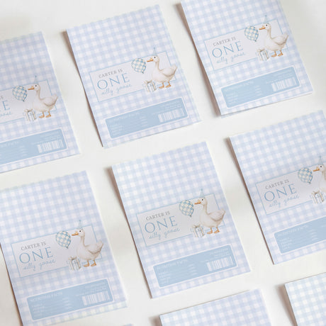 Set of first birthday chocolate wrappers, light blue gingham with 'ONE' and animal graphic