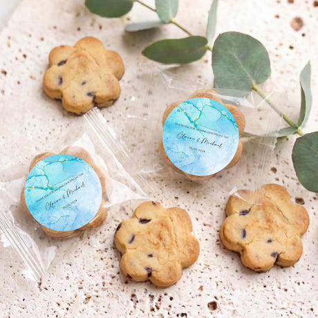Personalised bite-size choc chip cookies with blue marble labels on clear wrappers