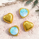 Foil-covered chocolate hearts in gold with personalized blue label on top