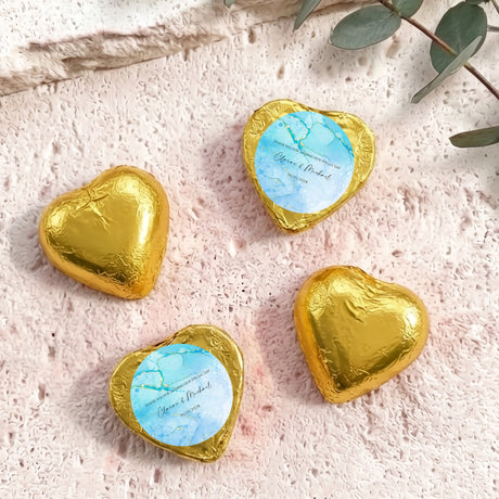 Foil-covered chocolate hearts in gold with personalized blue label on top