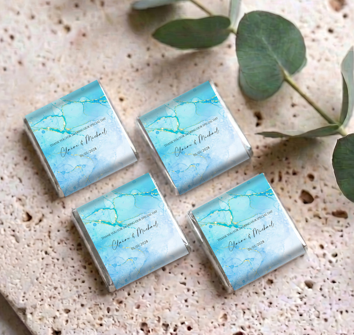 Four blue marble personalised mini chocolates with gold foil edges, script name and date