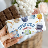 Space-themed chocolate bar wrapper with planets, rocket, and Spencer turns four text