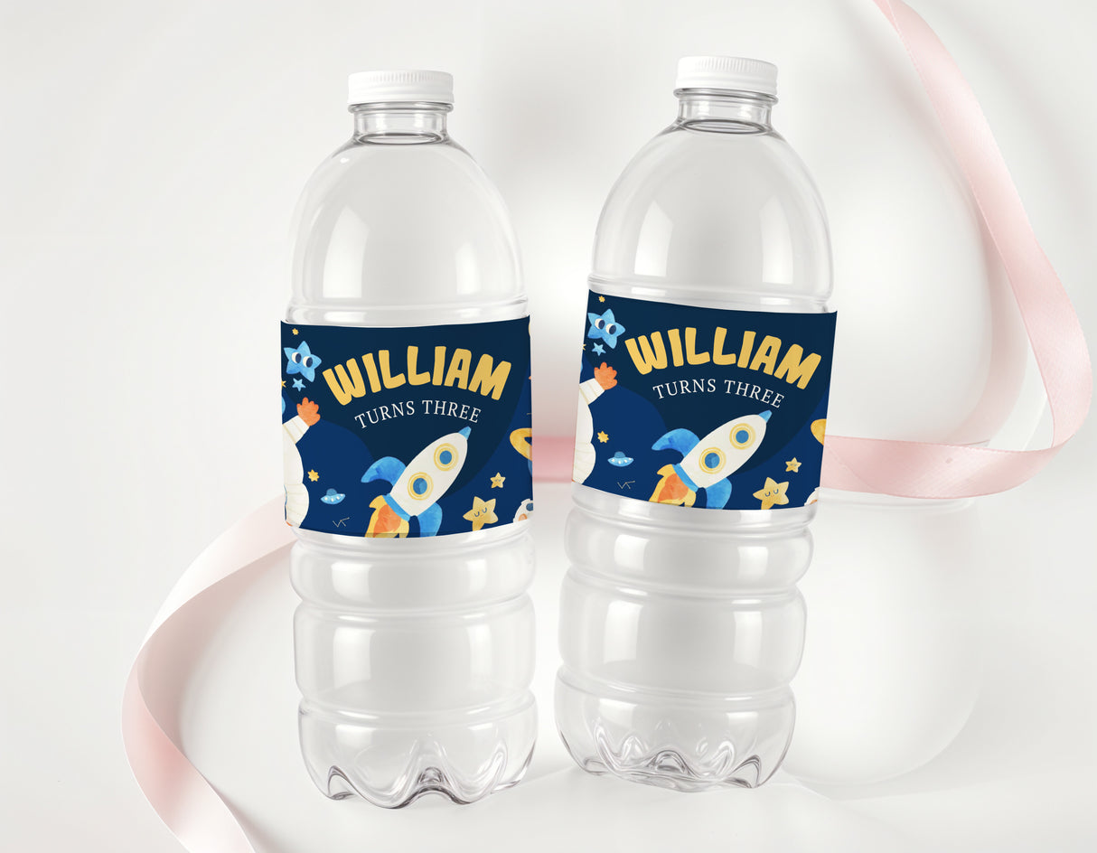 Personalised space navy birthday water bottle labels on clear plastic bottles