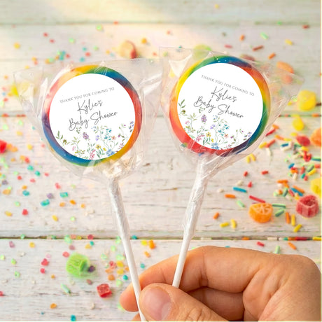Baby shower lollipops with rainbow rim wrappers and round floral thank-you labels