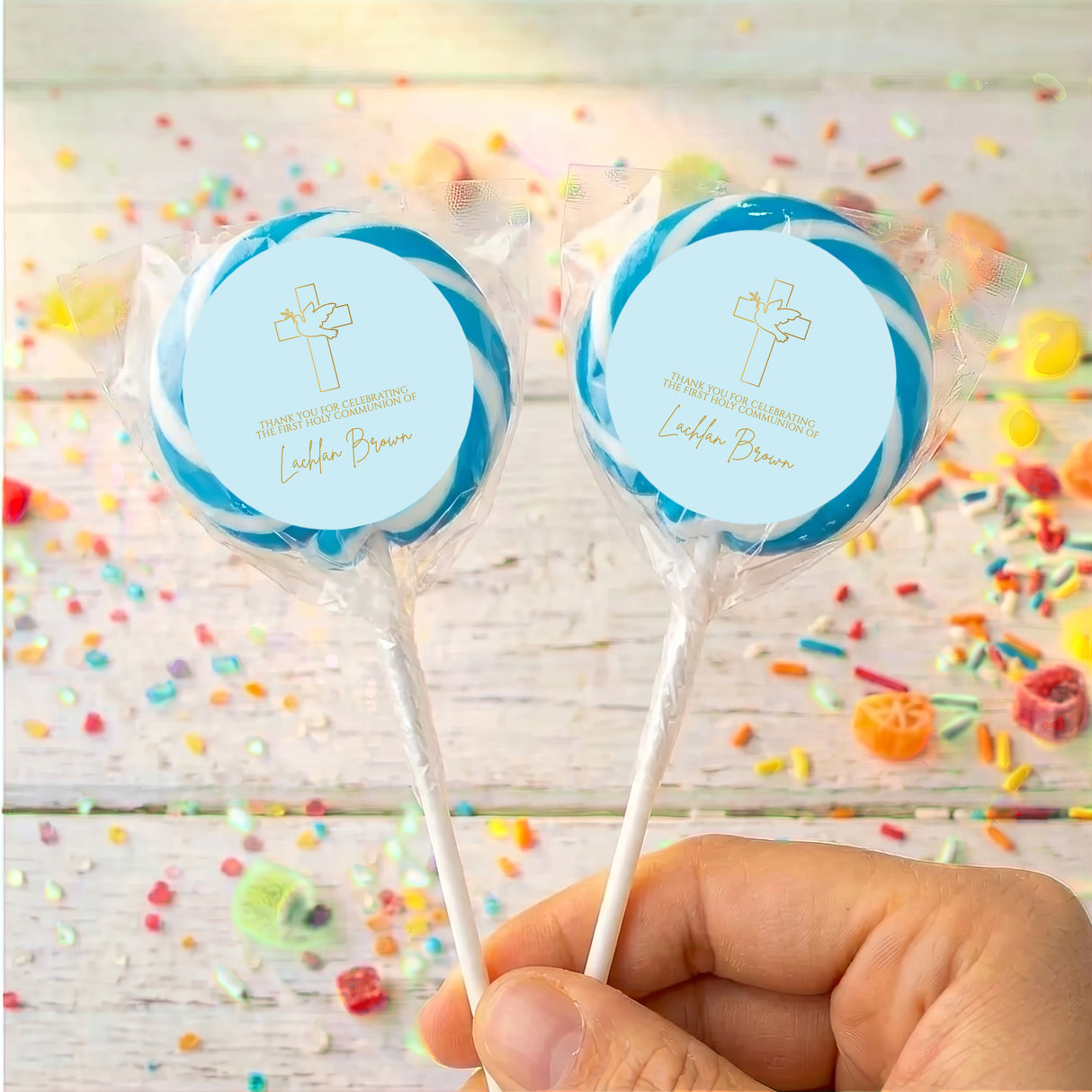 Personalised first communion lollipops with blue cross labels in clear wrappers