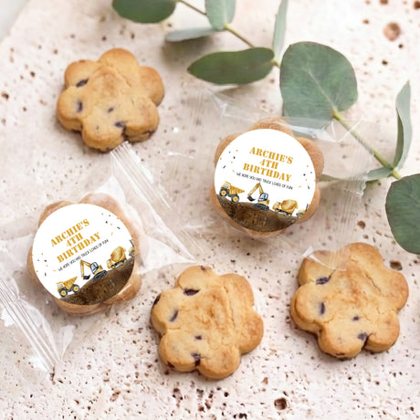 Assorted bite-size choc chip cookies with printed birthday tractor labels in clear wrappers.