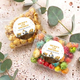 Two personalised popcorn bags with 'Archie's 4th Birthday' construction truck stickers