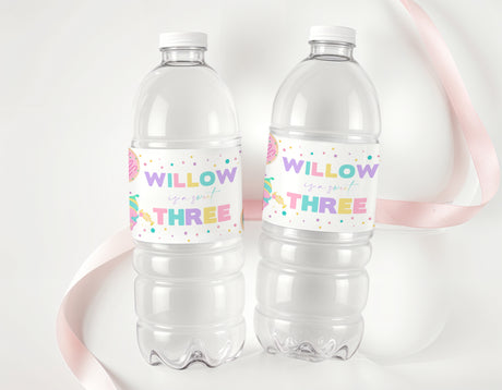 Personalised water bottle labels on two clear plastic bottles with 'WILLOW' and 'THREE' confetti