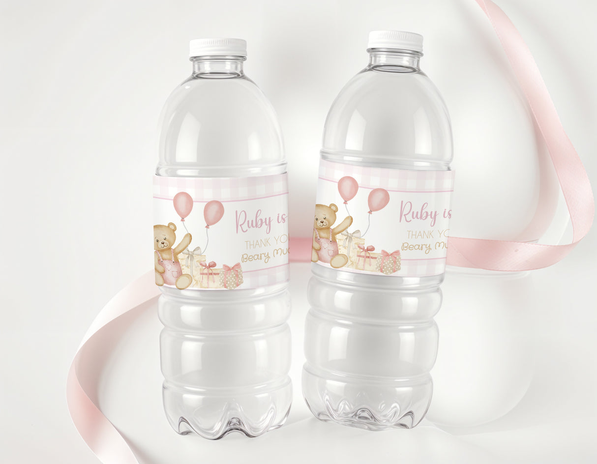 Two clear water bottles with pink teddy bear birthday labels, Ruby is