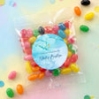 Personalised jelly bean bag with blue label, gold cross, filled with colorful jelly beans
