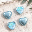 Blue foil heart chocolates for baptism, with light blue label and gold cross print