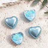 Blue foil heart chocolates for baptism, with light blue label and gold cross print