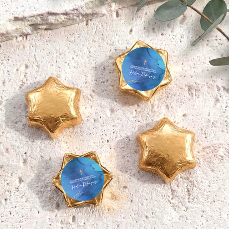 Gold foil chocolate stars with blue personalised circle label and gold cross
