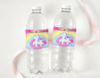 Clear water bottles with unicorn rainbow “Zara's 6th Birthday” labels, white caps