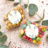 Two clear popcorn bags with round eucalyptus wreath personalised wedding labels