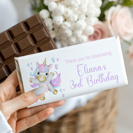 Birthday chocolate bar wrapper with dancing unicorn and pastel hearts, 'Eliana's 3rd'.