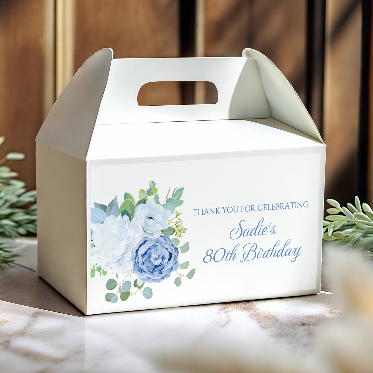 White gable favour box with blue rose floral print and 'Sadie's 80th Birthday' text