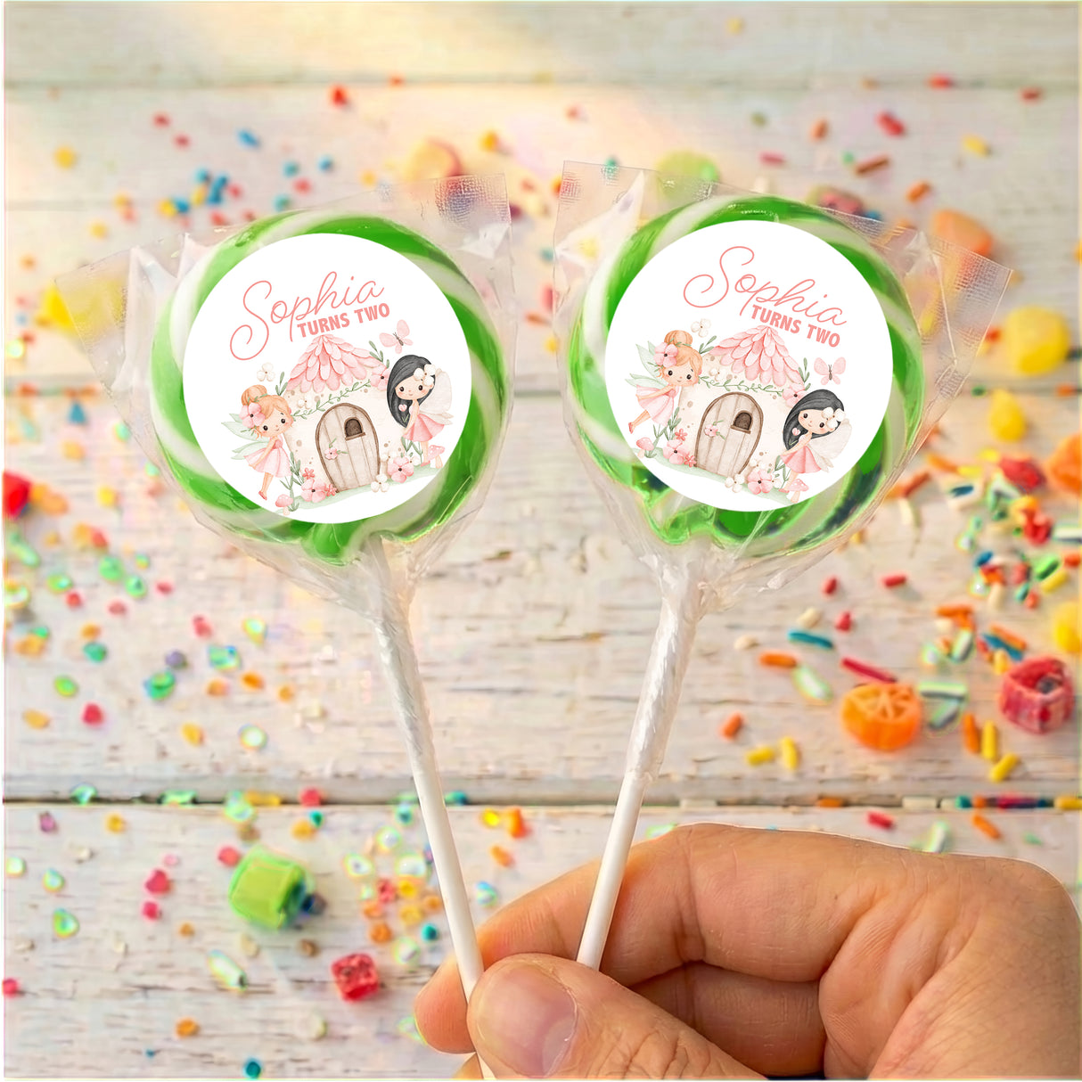 Personalised lollipops on sticks with round Sophia turns two labels, green border
