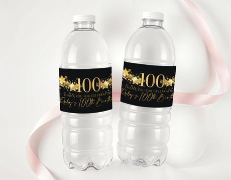 Personalised 100th birthday bottle labels with black and gold 100 on two bottles
