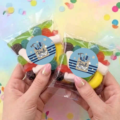 Two personalised lolly bags with clear plastic, blue Dad labels, assorted candies