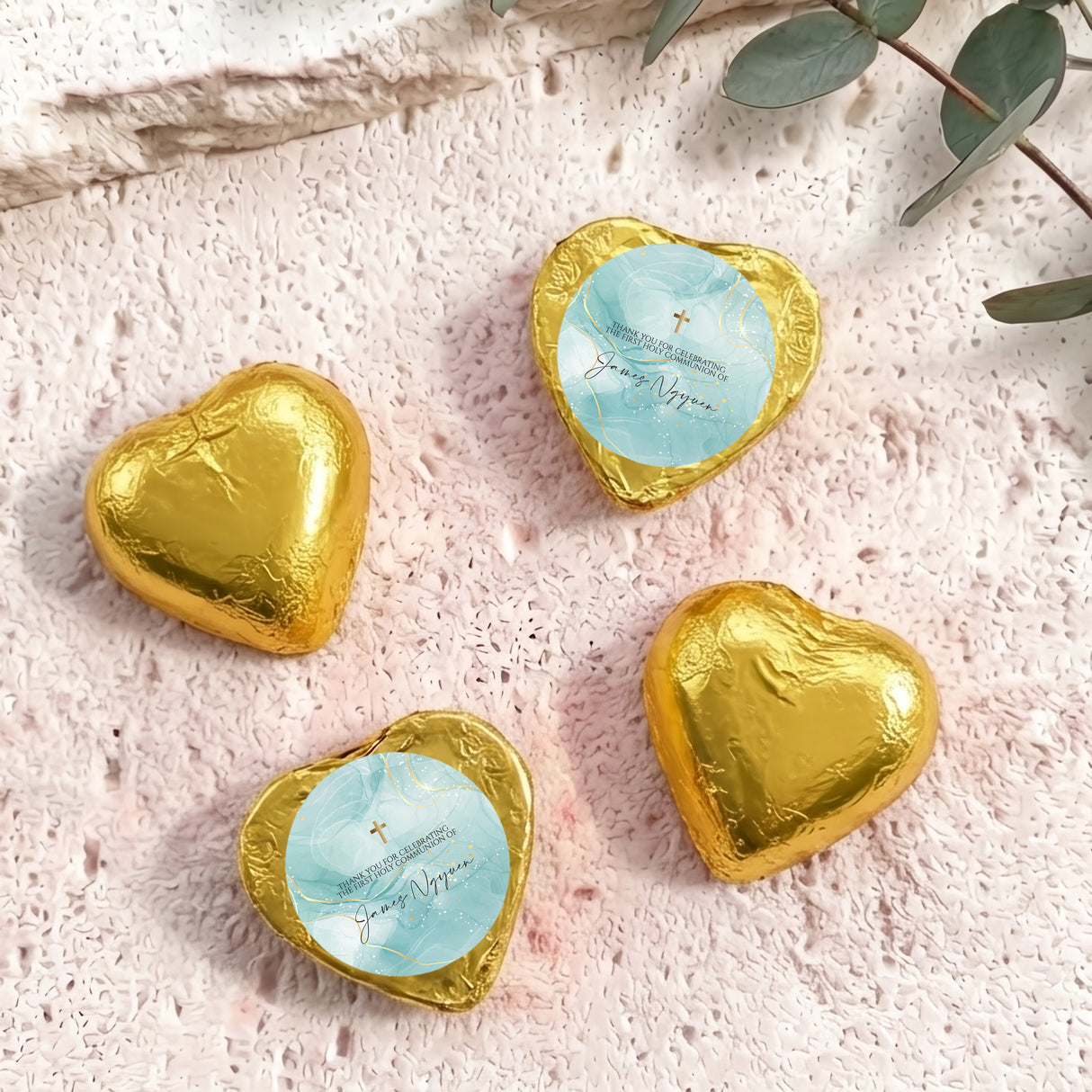 Gold foil heart chocolates with blue center label and gold cross