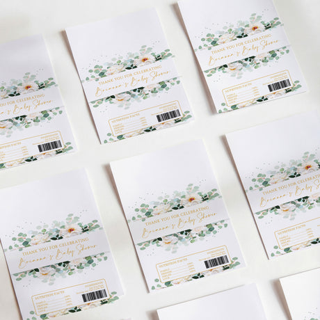 Baby shower chocolate wrappers with white base, green and floral greenery design, barcodes