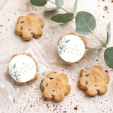 Pack of personalised bite-size choc chip cookies with two round baptism labels and gold cross