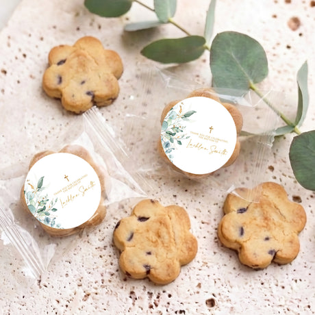 Pack of personalised bite-size choc chip cookies with two round baptism labels and gold cross