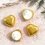 Gold foil heart chocolates with baptism cross and floral label on white center
