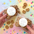 Personalised pretzel bags with brown pretzels and round floral thank-you labels